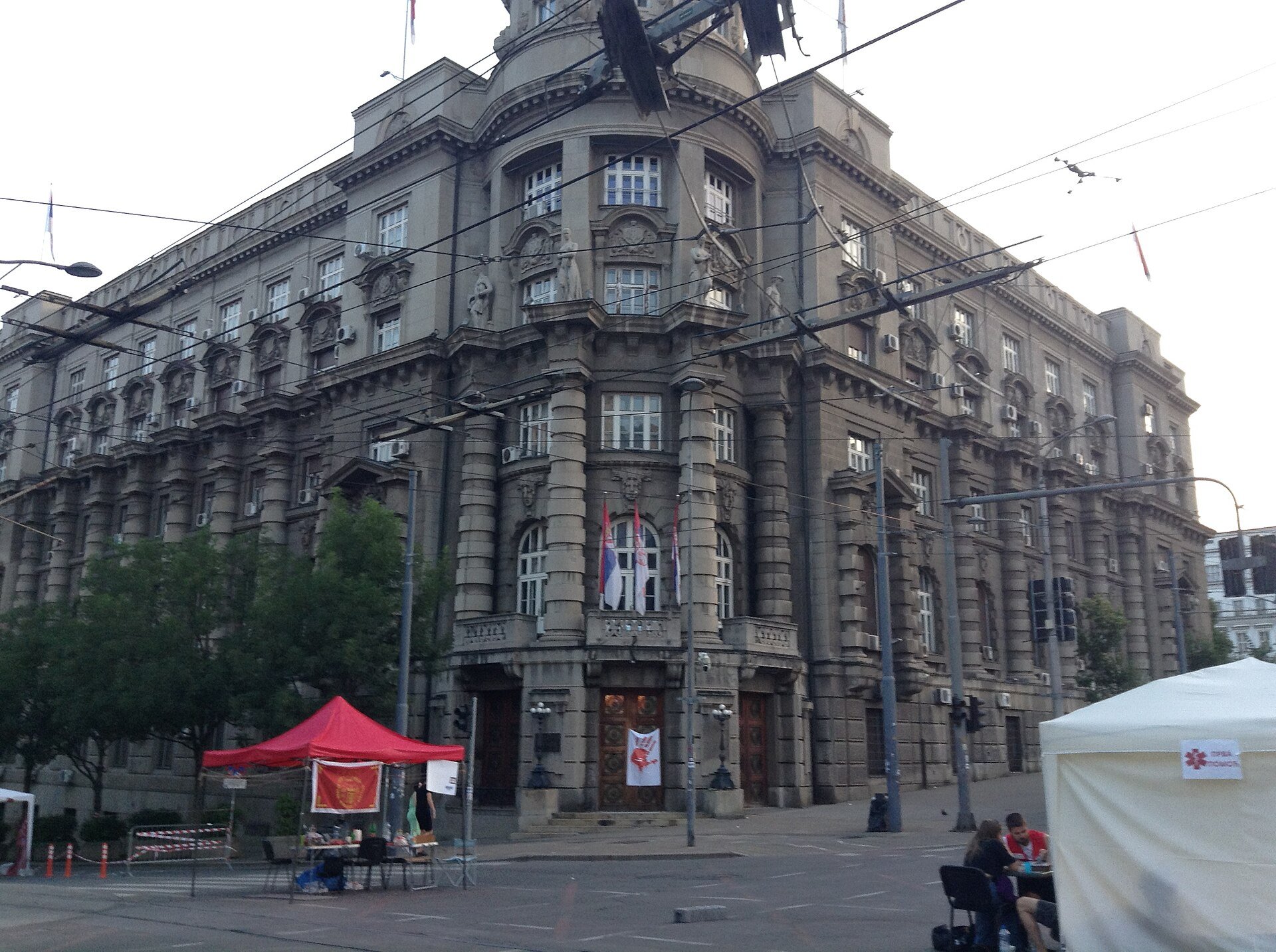 A red handprint protest symbol outside the Government of Serbia building in Belgrade