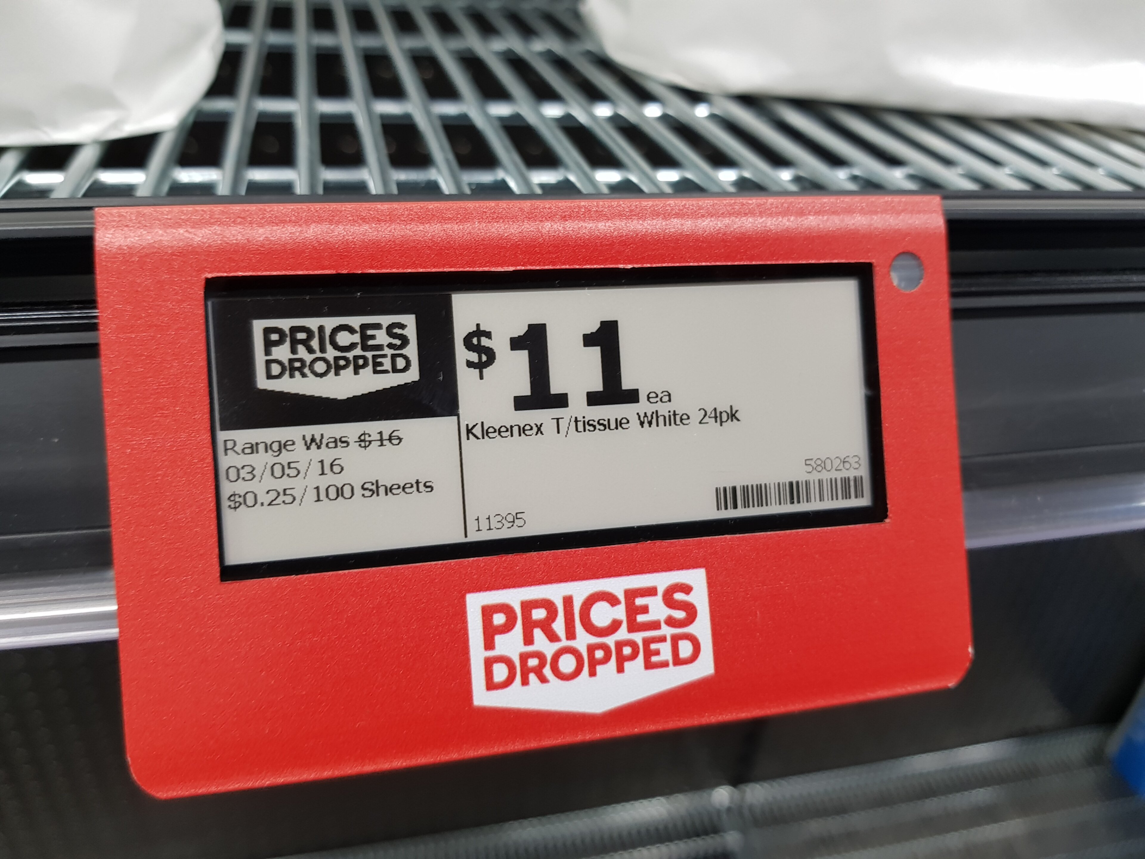 An electronic shelf price tag in a supermarket aisle
