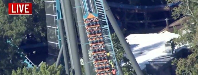 Aerial news helicopter view of the Goliath coaster train stopped on the track at Six Flags Over Georgia with riders still aboard