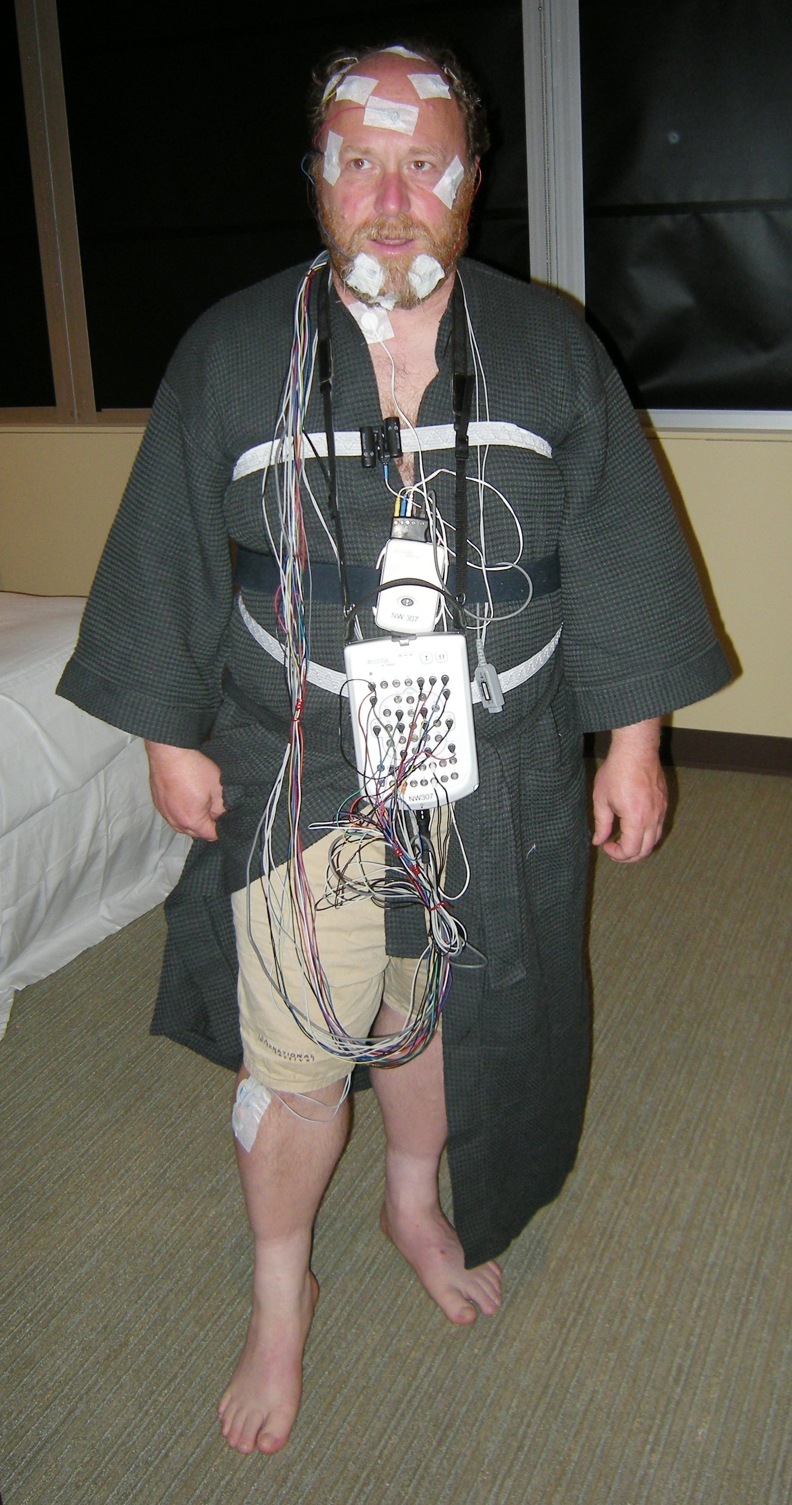 A man wired up with sensors for an overnight sleep study