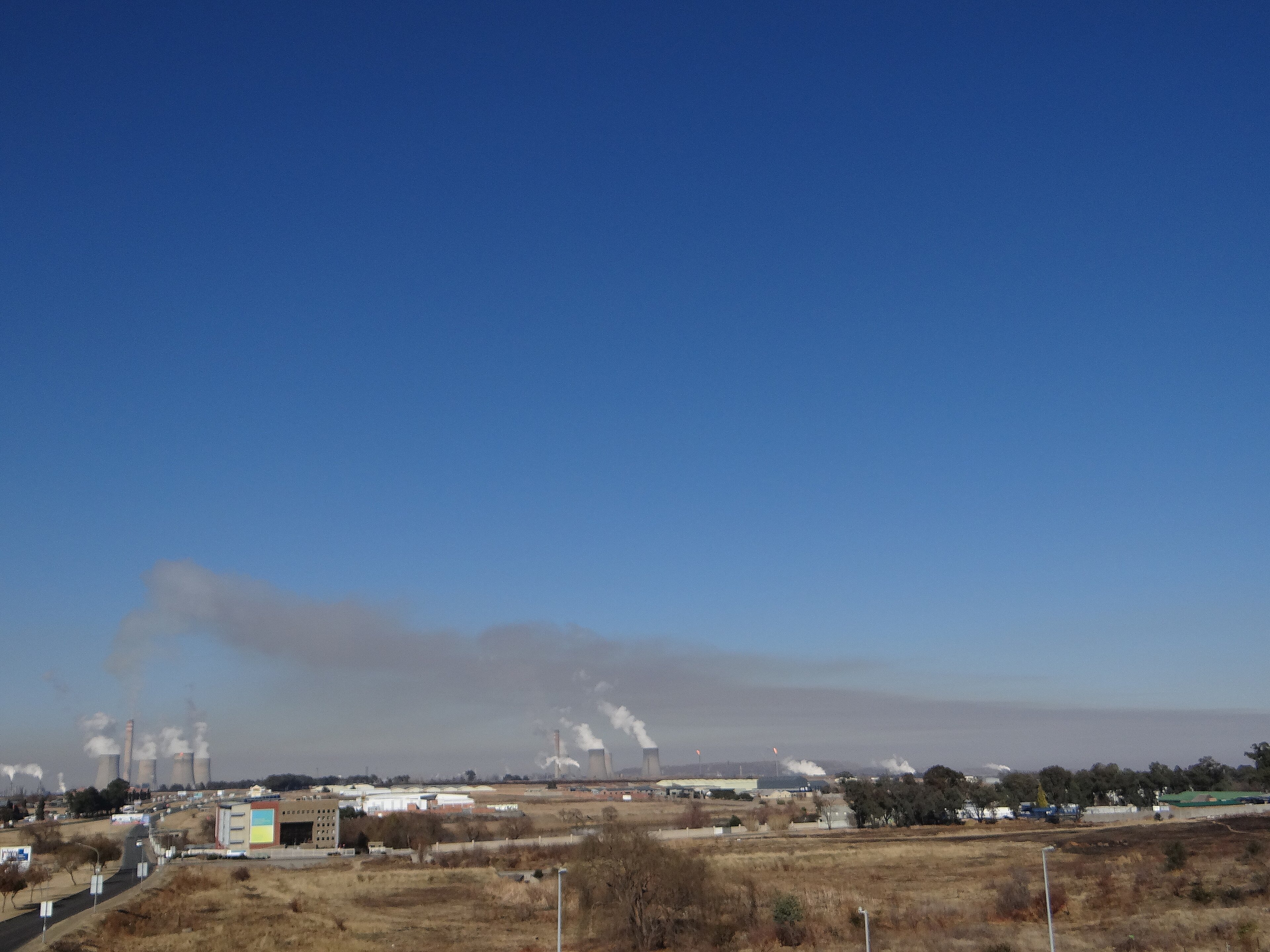 Sasol's Secunda plant seen from the town of Secunda, with industrial towers on the horizon