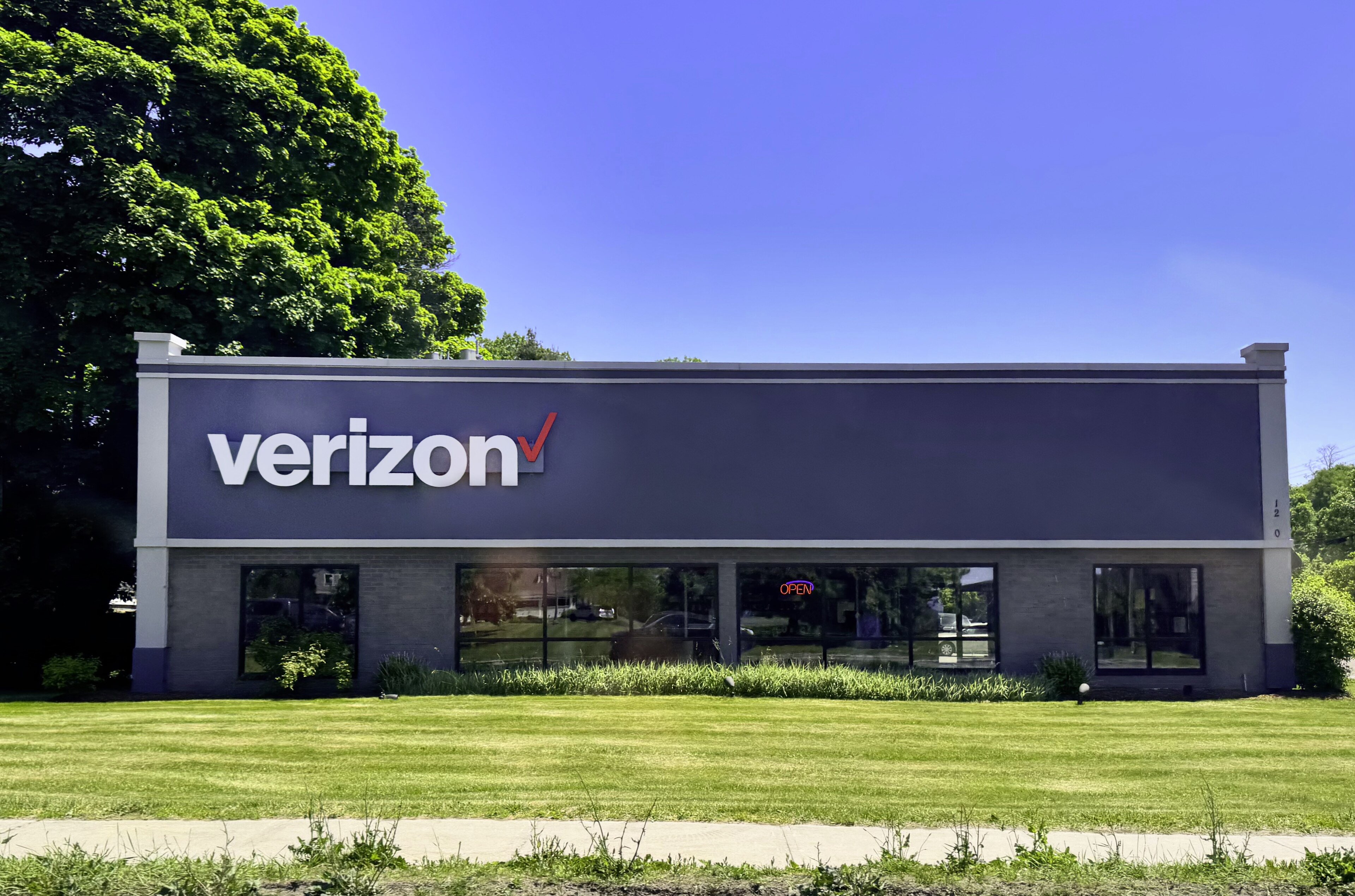 A Verizon retail store in Burlington, Vermont, with its red logo above a glass shopfront