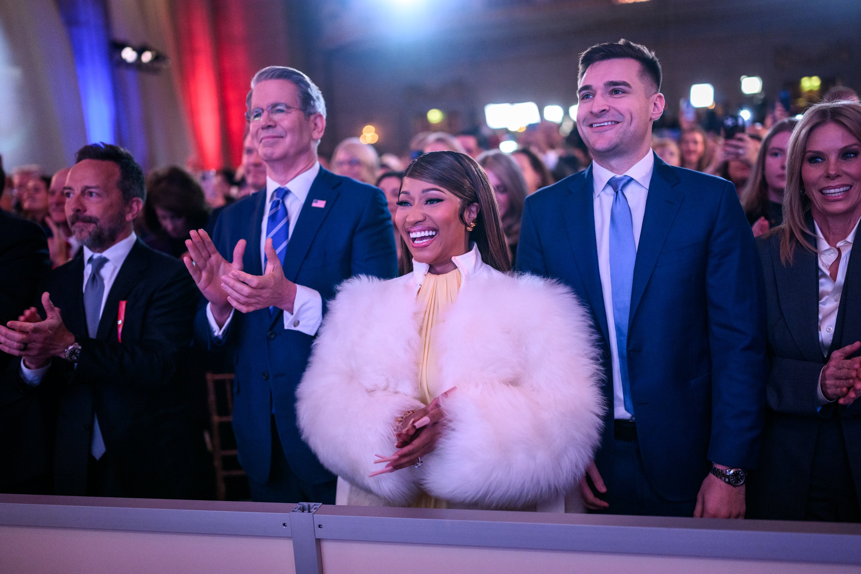 Guests cheer at a Trump Accounts event in a packed hall in Washington