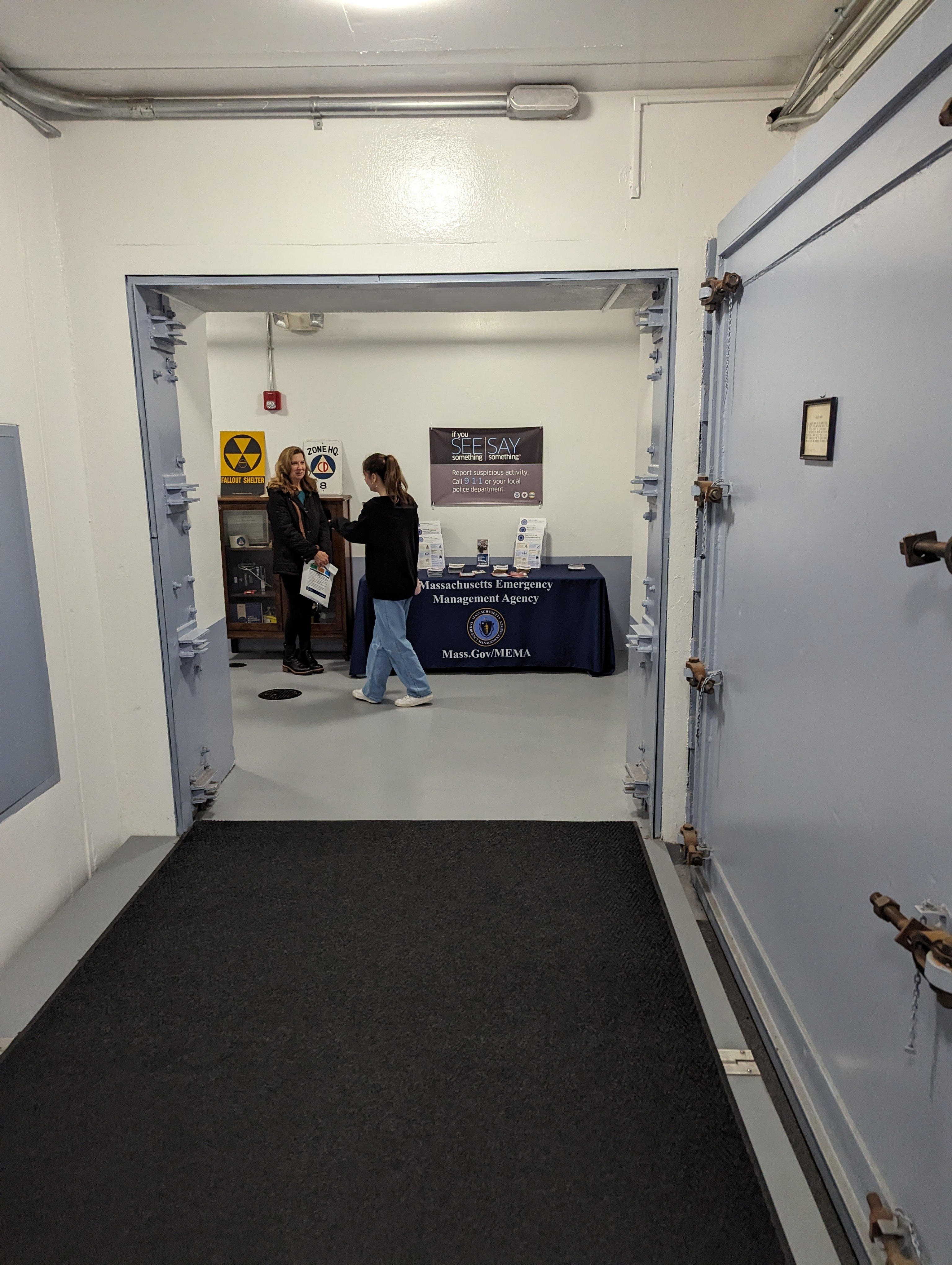The underground entrance of a bunker with a heavy blast door