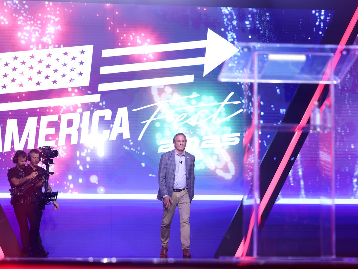 Texas Attorney General Ken Paxton walking on stage at AmericaFest 2025 in Phoenix