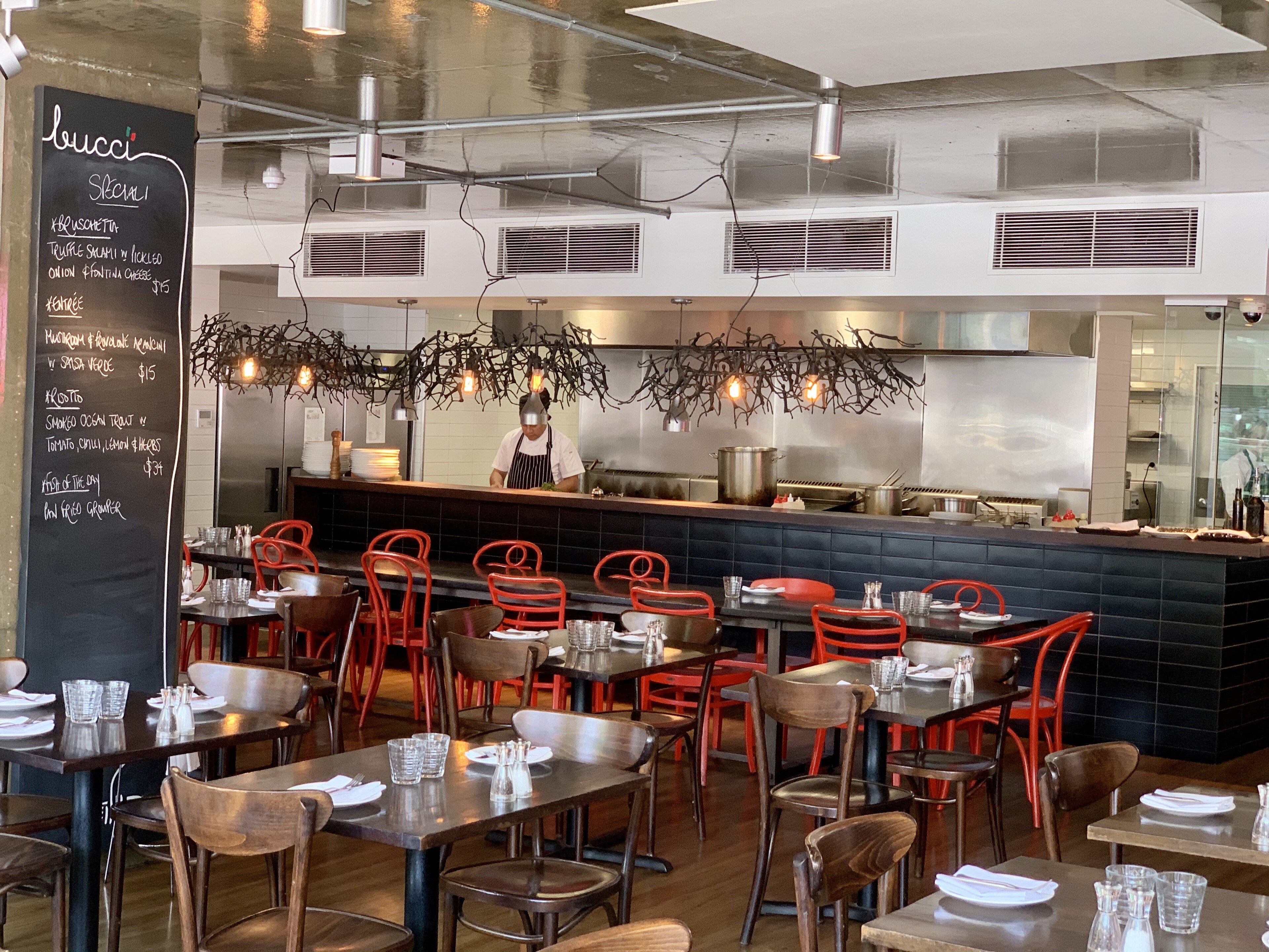 A stainless steel restaurant kitchen counter with clean surfaces and no staff present