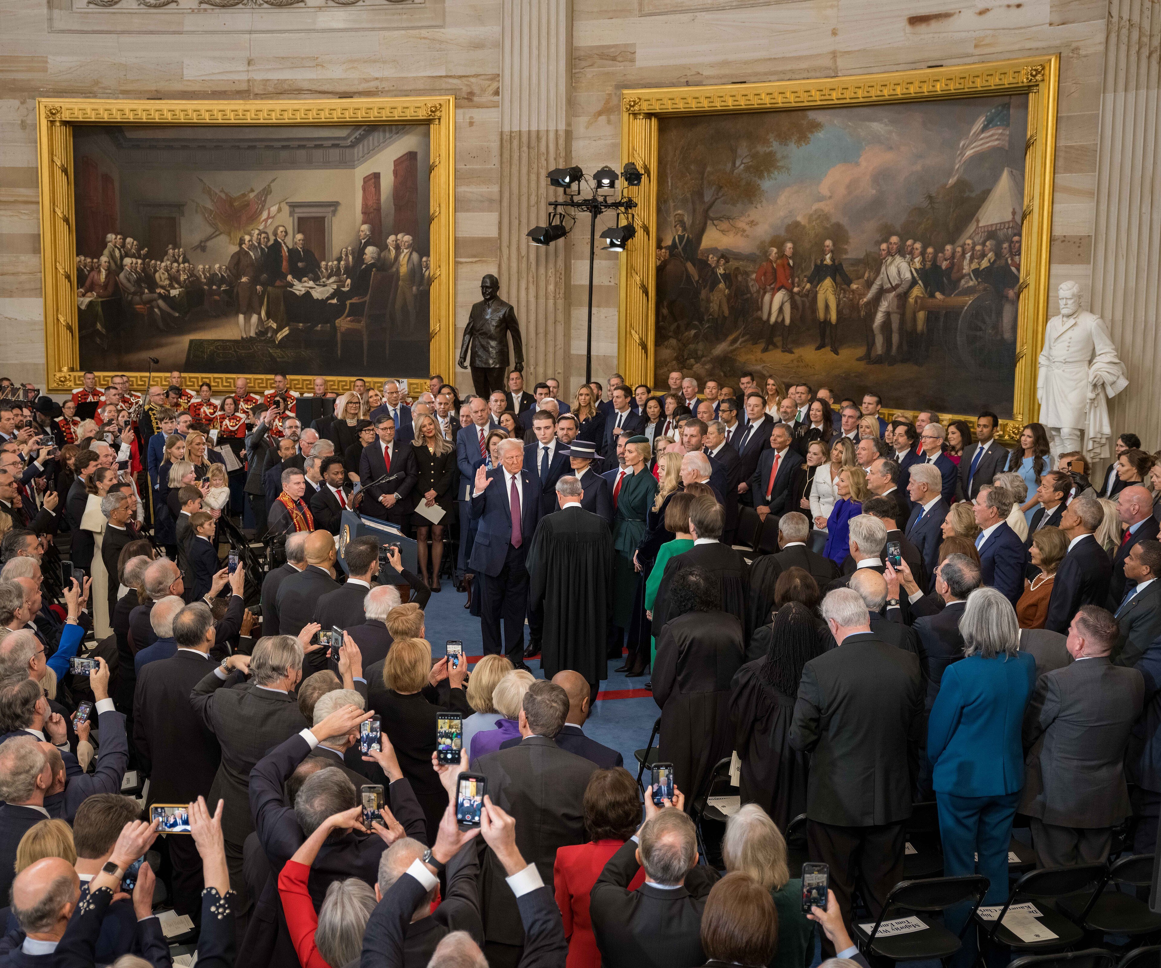 Donald Trump raises his right hand to take the oath of office at his second inauguration in January 2025