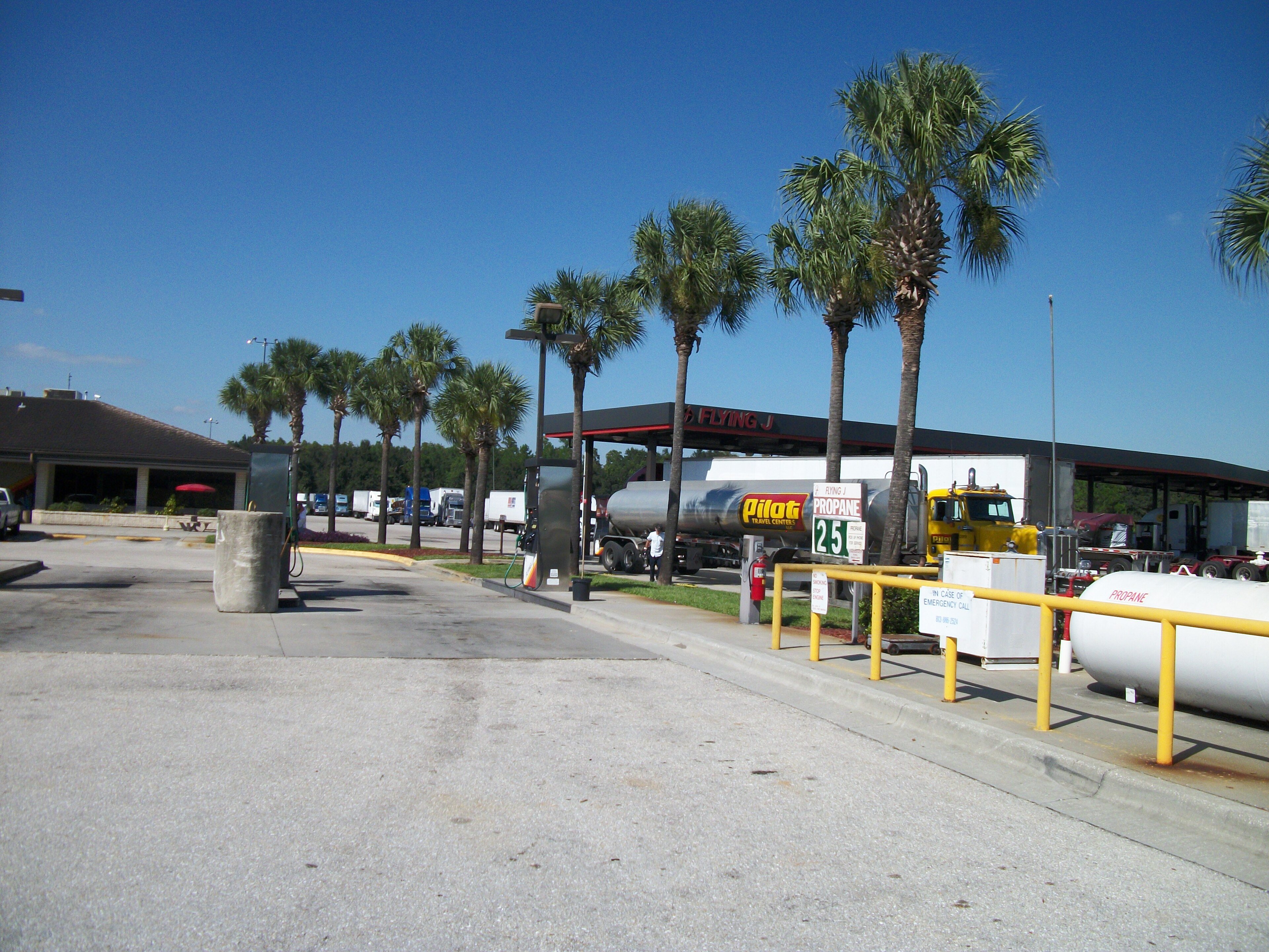 A tanker truck filling up with diesel at a truck stop