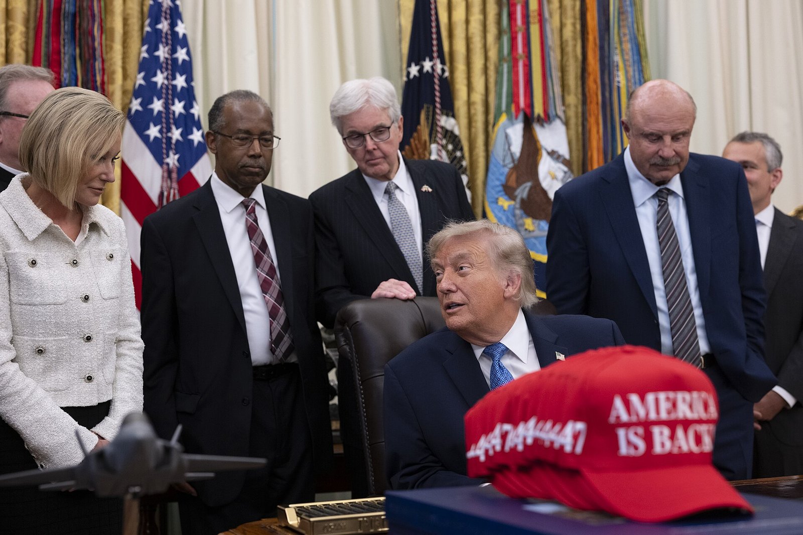 President Donald Trump speaking to the press from his desk in the Oval Office