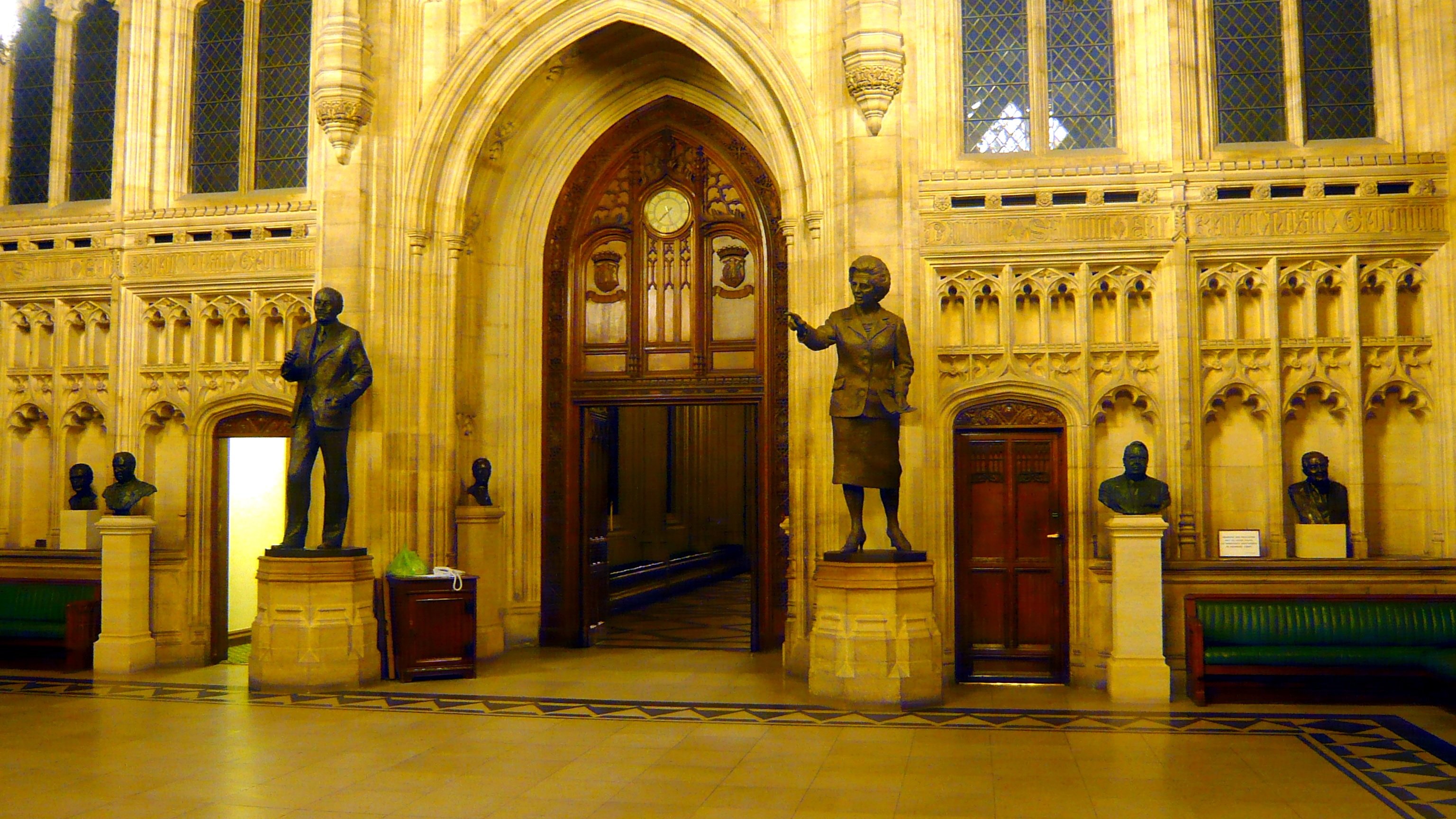 The Members' Lobby outside the House of Commons chamber, with bronze statues and stone arches