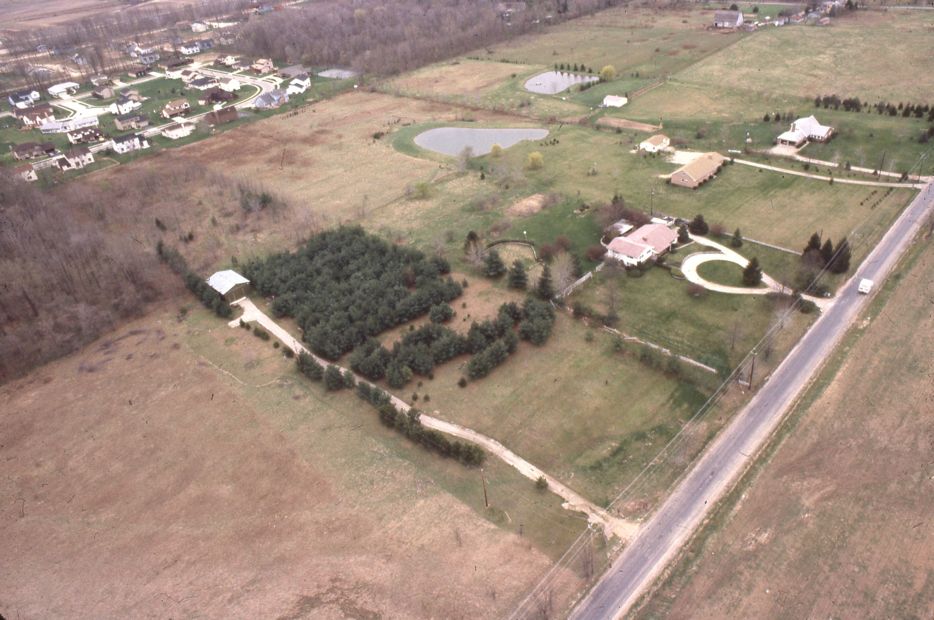 An aerial view of a US suburban neighborhood, the kind of market where homes now sit for months