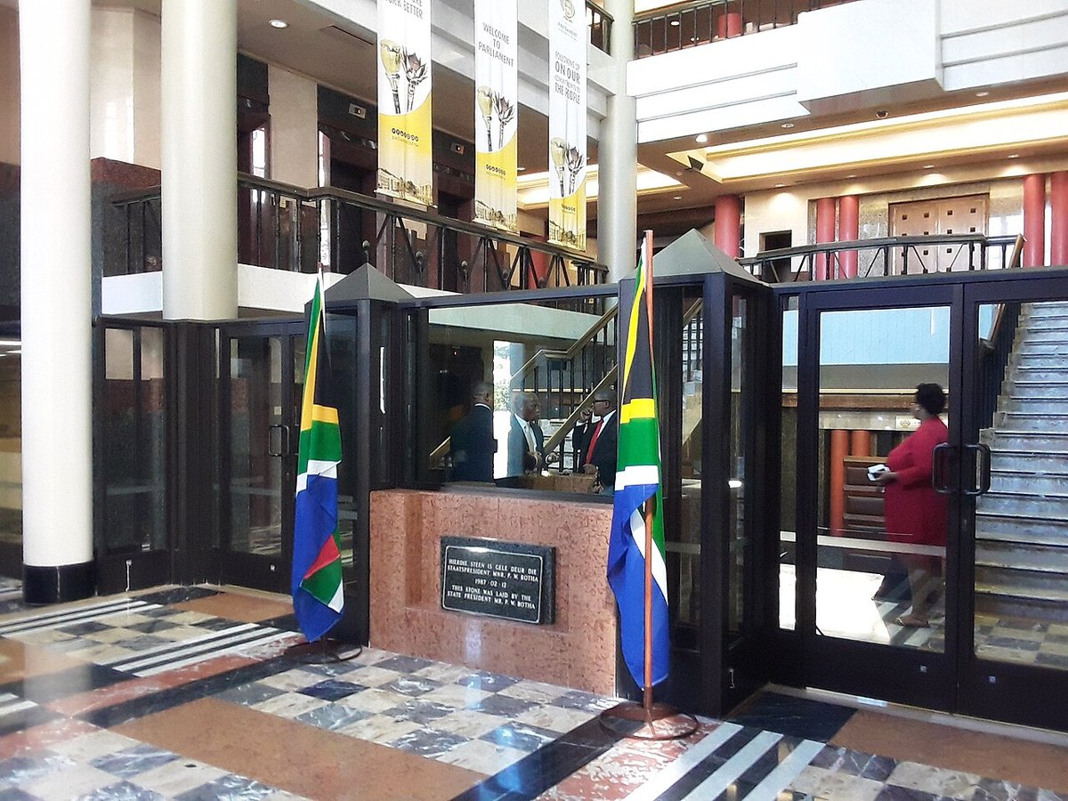 The entrance hall inside the main building of Parliament in Cape Town with two South African flags